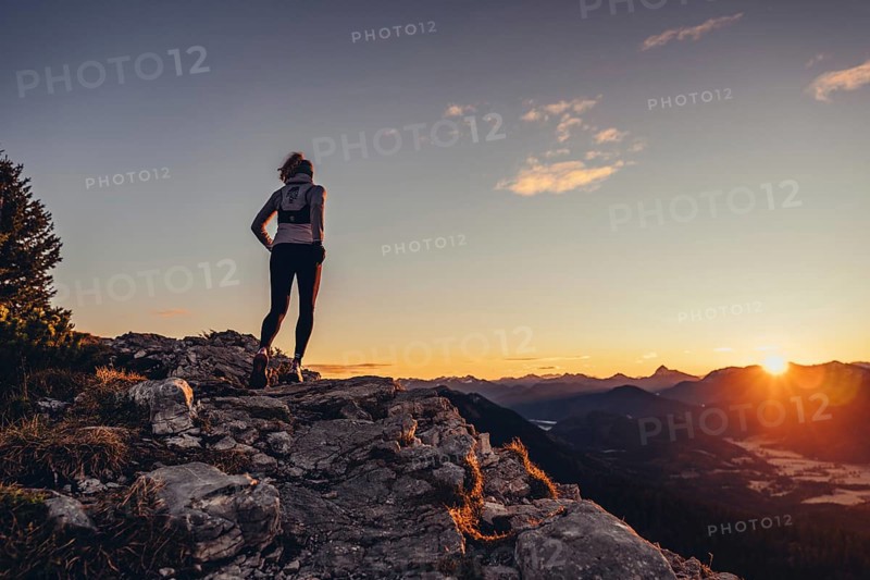 Trail running in autumn on the Jochberg on Lake Walchensee against the wonderful backdrop of the Alps, Bavaria, Germany, Europe