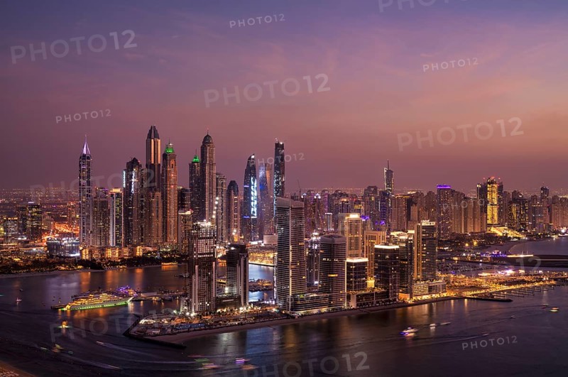 Night shot, view from The View At the Palm viewing platform of skyline with Princess Tower, Elite Residence, luxury yacht OPERA owned by Sheikh Mansour bin Zayed Al Nahyan from the ruling family of the Emirate of Dubai, anchored in front of EMAAR Beachfront, logo, DAMAC, evening mood, Dubai Marina, Dubai, United Arab Emirates, VAR, Asia