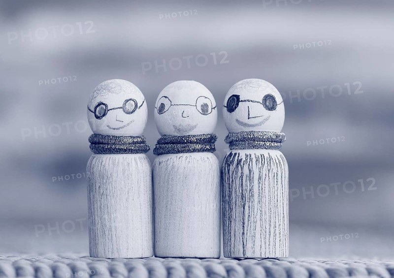Three small funny wooden cones, monochrome in front of a painted background, North Rhine-Westphalia, Germany, Europe