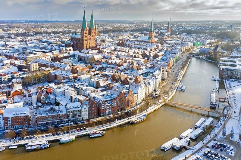 Aerial view over the river Trave and church towers in the old town of the Hanseatic City of Lübeck in winter, Schleswig-Holstein, Germany, Europe
