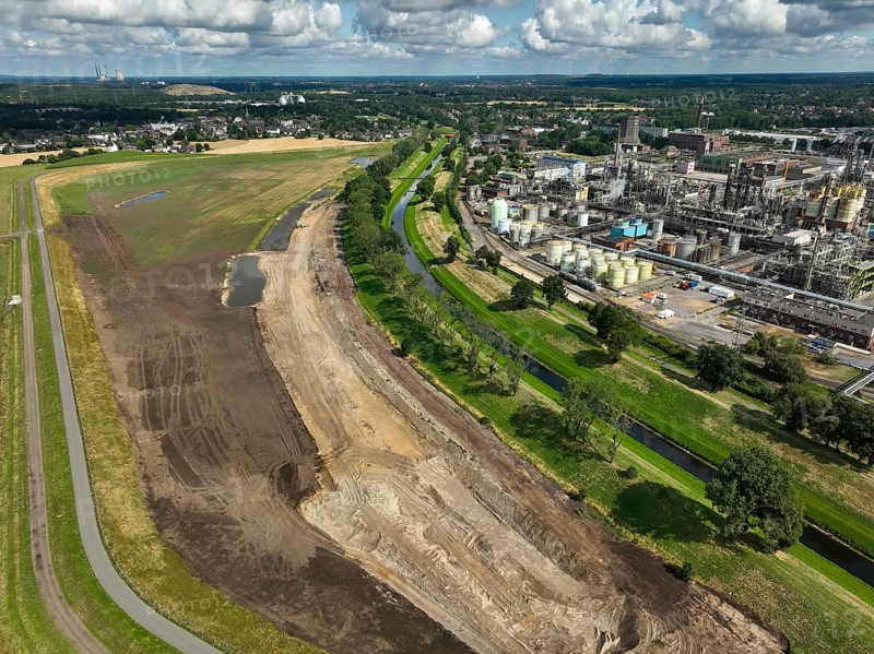 Oberhausen, North Rhine-Westphalia, Germany, renaturalisation of the Emscher in the Holtener Bruch. A new floodplain landscape for flood protection and biodiversity is being created here. On the right, OQ Chemicals plant Ruhrchemie. The Emscher, which is currently straightened, is given curves again and can meander through its new floodplain. The ecological reorganisation of the Emscher system consists of the construction of a central wastewater treatment system in the Ruhr area, the construction of sewers and the renaturation of the Emscher and its tributaries. Following the construction of a parallel sewer, the Emscher has been completely free of sewage since January 2022. The river was previously an open, above-ground combined sewer with rainwater and wastewater, Europe