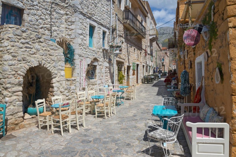 Dreamy alley with colourful houses and a cosy bistro area, Old Town, Areopoli, Areopolis, Tsimova, Itylo, Anatoliki Mani, Mani, Laconia, Peloponnese, Greece, Europe