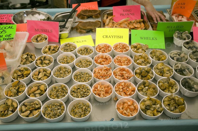 Fishmonger display of varieties of shellfish on ice sale