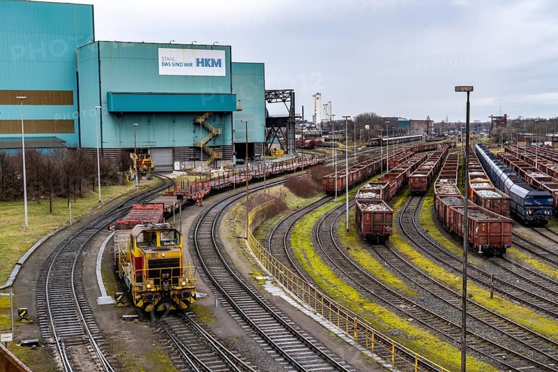 Hüttenwerke Krupp-Mannesmann, HKM in Duisburg, halls of the blast furnace steelworks, tracks of the marshalling yard, freight wagons with scrap metal, for melting down, North Rhine-Westphalia, Germany, Europe