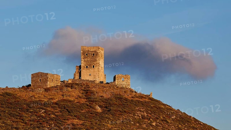 Sunset colours the clouds over the imposing ruins of a fortress on a mountain, residential tower on a mountain, Mani peninsula, Peloponnese, Greece, Europe