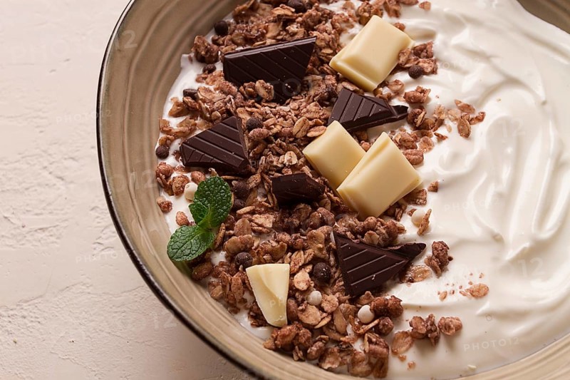 Yogurt with chocolate muesli, breakfast, close-up, fork on top, no people