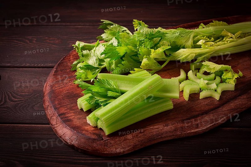 Fresh bunch of celery, top view, no people, on a dark background