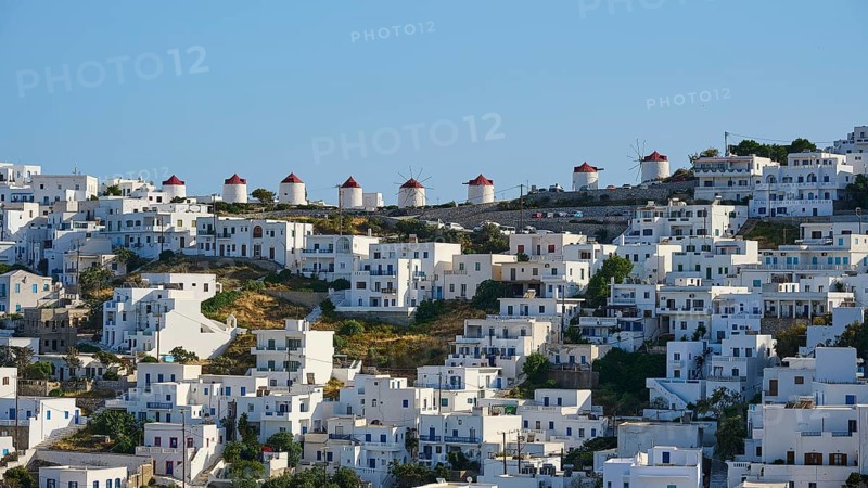 Traditional windmills line up next to white houses on a sunny hillside, Chora, Astypalea, Dodecanese, Greek Islands, Greece, Europe