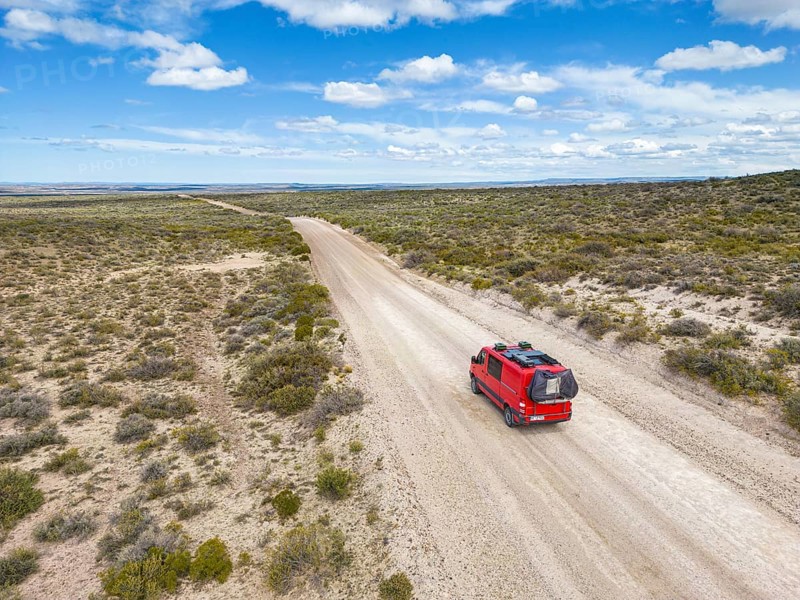 4x4 campervan drives along the road near Estancia la Maciega, Chubut, Argentina, South America