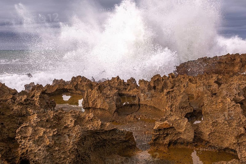 The rocks are scattered throughout the area, with some of them being large and jagged. The water appears to be rough. Rabat, Morocco, Africa