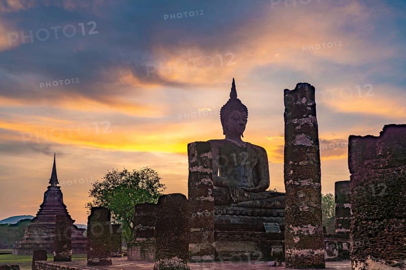 Sunset at a Buddha statue of the temple Wat Mahathat, UNESCO World Heritage Sukhothai Historical Park, Thailand, Asia