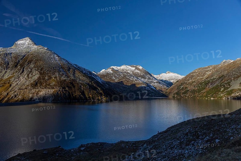 Kölnbrein reservoir and the Oberlecherspitzen mountain on a bright sunny morning. Seen from the Malta Hochalm road. Carithia, Austria, Europe