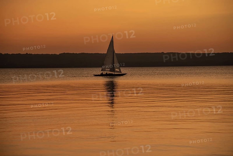 Sailing boat in the sunset with sunset on the Lake Ammer near Herrsching, Bavaria, Germany, Europe