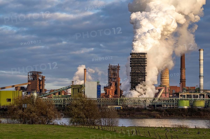 Industrial backdrop of the ThyssenKrupp Steel steelworks in Duisburg-Bruckhausen, on the Rhine, blast furnaces, Schwelgern coking plant, extinguishing cloud, Duisburg, North Rhine-Westphalia, Germany, Europe