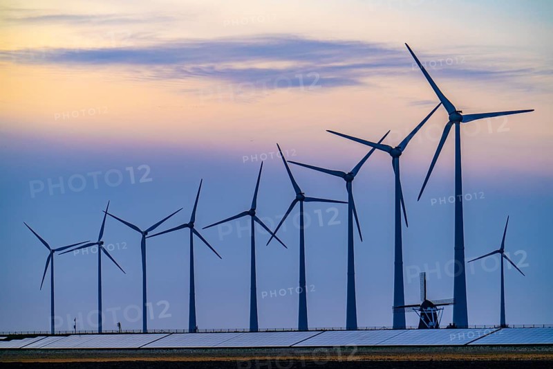 Windmill Poldermolen De Goliath stands between the high-tech wind turbines in Eemshaven, historic windmill from around 1882, rebuilt and reconstructed several times, Westereems wind farm, solar farm on sea dike, Slaperdijk, a good 5 kilometres long, Netherlands