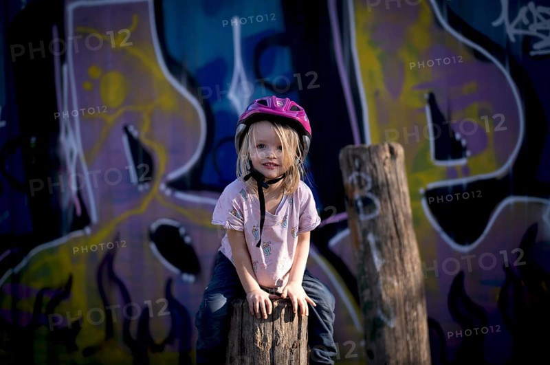 Little girl, 3 years, blonde, climbing, post, climbing facility, climbing frame, in front of wall full of graffiti, helmet, playground, Stuttgart, Baden-Württemberg, Germany, Europe