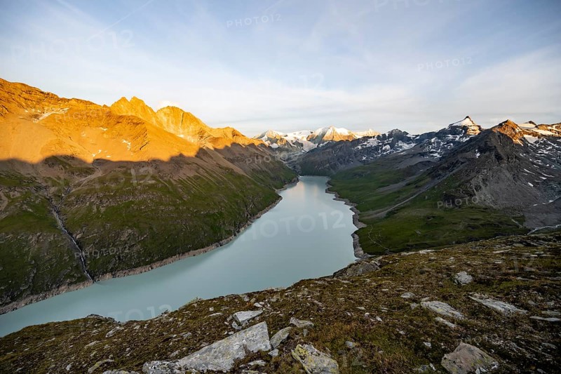 Picturesque mountain landscape at the summit Mont de la Blana at sunset, view of blue mountain lake, reservoir Lac des Dix and summit Mont Blanc de Cheilon with glacier, Hérémence, Valais, Western Alps, Switzerland, Europe