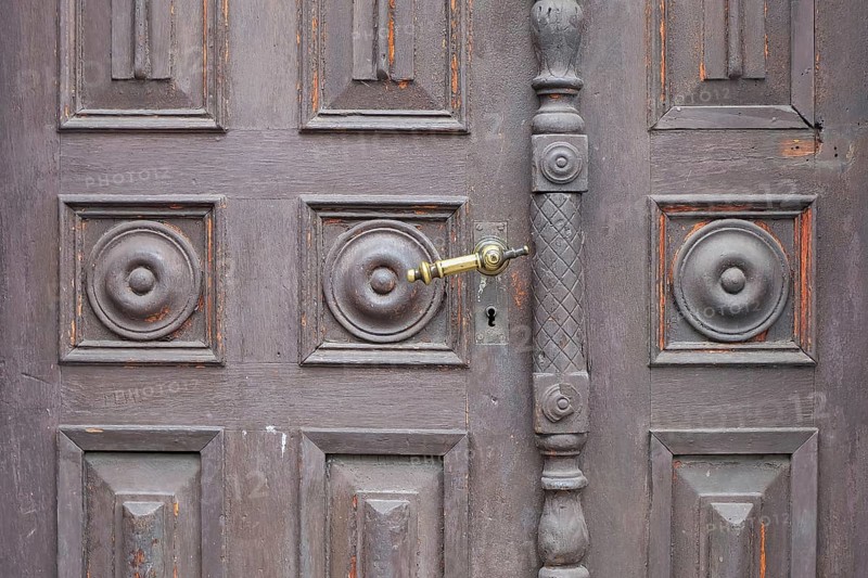 Old antique wooden door with decorative round patterns and a metal door handle, St. Martin, Southern Palatinate, Palatinate, Rhineland-Palatinate, Germany, North America