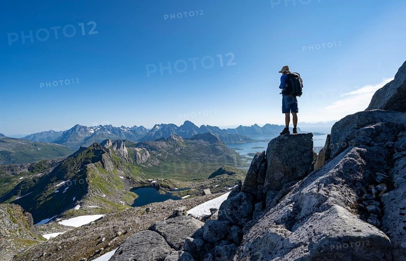 View of mountains and fjord landscape, mountain panorama, mountaineer at the summit of Rundfjellet, lake Hellskarvatnet, Svolvaer, Nordland, Norway, Europe
