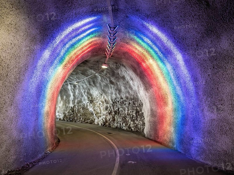 Colorful illuminated tunnel for bicycles and pedestrians leads up to Hardanger suspension bridge, Hardanger, Norway, Europe