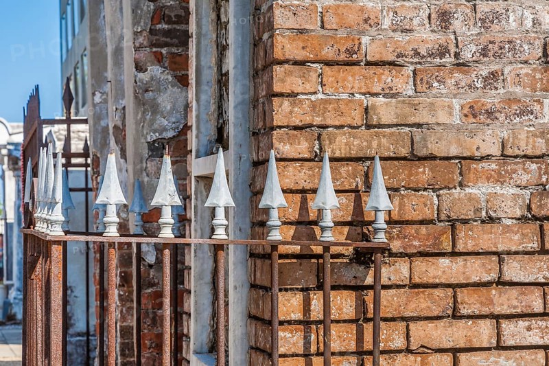 Arrowhead spikes on wrought iron fence at an above ground grave in St. Louis Cemetery No. 1 in New Orleans, Louisiana, USA, North America