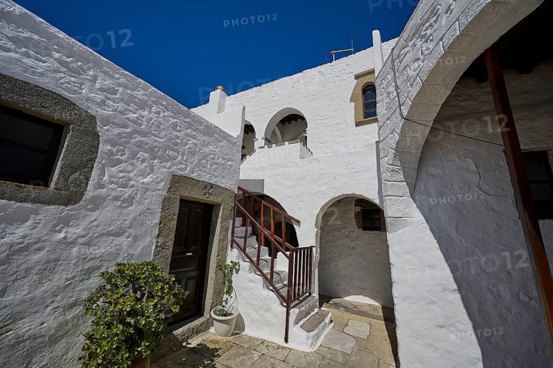 Courtyard of a historic building with white walls and a wooden staircase, Inside the monastery, Agiou Theologou Monastery, Chora, Patmos, Dodecanese, Greek Islands, Greece, Europe