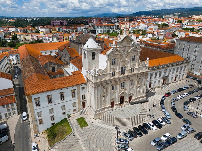 Historic baroque church in the city with a square in front of it and parked cars, aerial view, Cathedral, Coimbra, Rio Mondego, Portugal, Europe