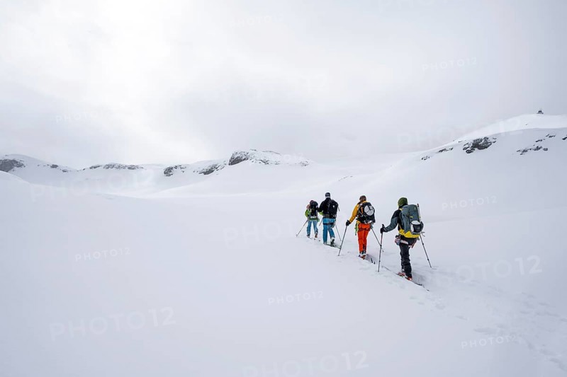 Group of ski tourers, Snowy mountain landscape, Bernese Alps, Bernese Oberland, Switzerland, Europe