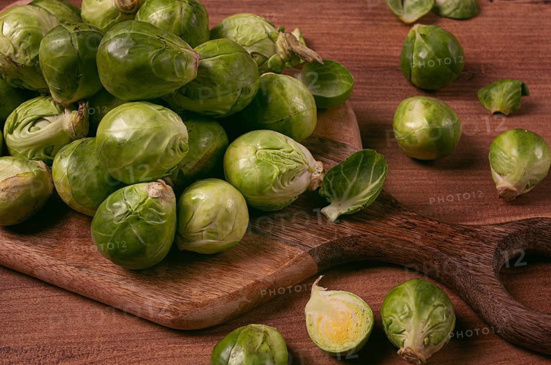Fresh Brussels sprouts, raw, top view, on a wooden table, no people