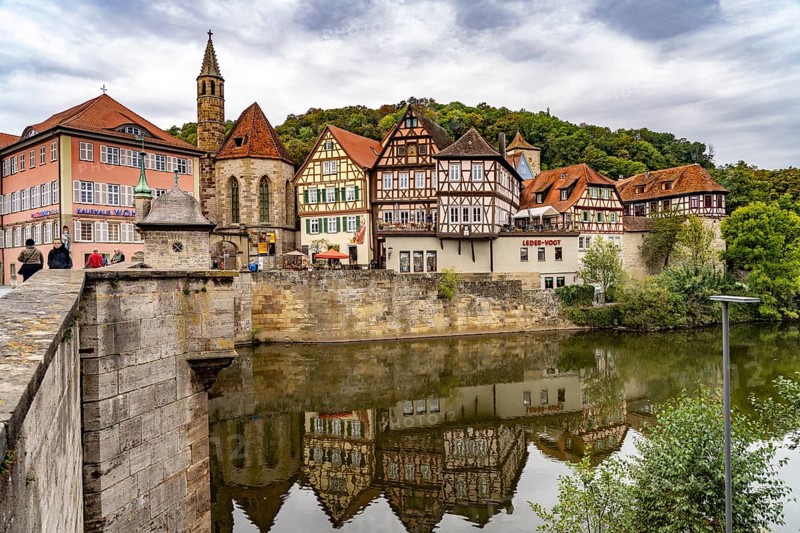 Half-timbered houses on the Kocher and St John's Church in Heimbach, Schwäbisch Hall, Baden-Württemberg, Germany, Europe