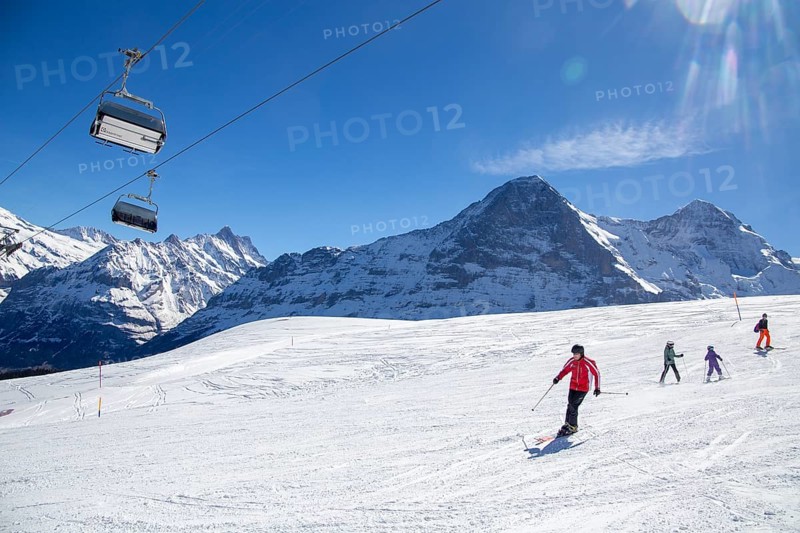 25 March 2024: Skiing against the backdrop of the north face of the Eiger in Grindelwald, Switzerland, Europe