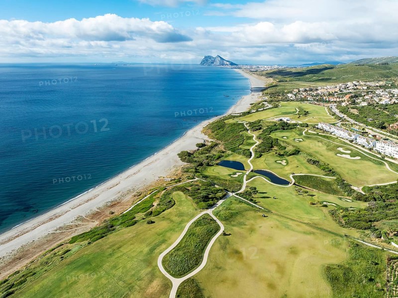 The La Hacienda Links Golf Resort at the Mediterranean Sea with the Rock of Gibraltar (British) in the distance. Aerial view. Drone shot. Cádiz province, Andalusia, Spain, Europe