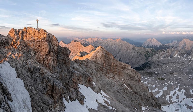 Summit of the Zugspitze with golden summit cross, alpenglow at sunset, Northern Limestone Alps, Wetterstein Mountains, Bavaria, Germany, Europe