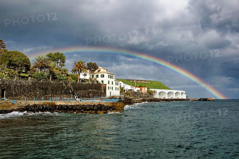 Promenade in rainy weather with rainbow on the beach of the Atlantic Ocean, municipality of Santa Cruz, Madeira, Portugal, Europe