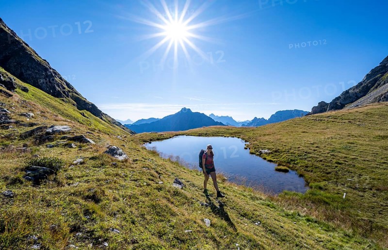 Hiker on the Carnic High Trail, small mountain lake, Carnic Main Ridge, Carnic Alps, Carinthia, Austria, Europe