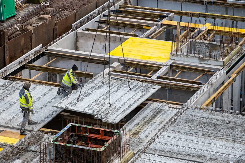 Construction site, installation of semi-precast floor slabs, which are then filled with in-situ concrete