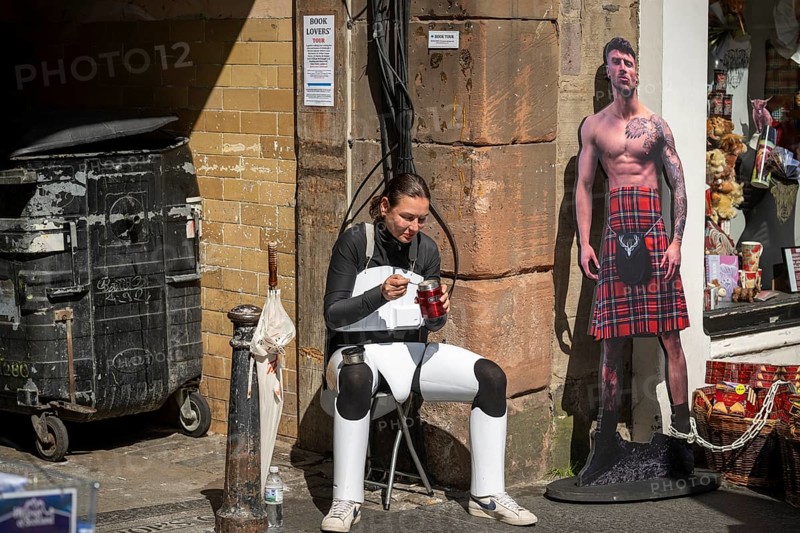 Participant taking a lunch break, world's largest cultural festival The Fringe, High Street, Edinburgh, Scotland, United Kingdom, Great Britain, Europe