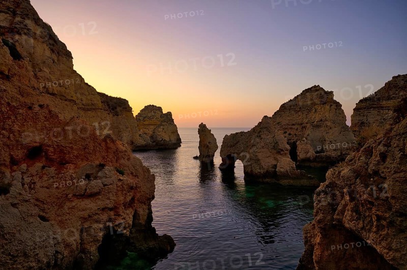 Coloured cliffs and sunrise, rocks in the sea, Ponta da Piedade, Lagos, caves, cliffs, Atlantic Ocean, Algarve, Portugal, Europe