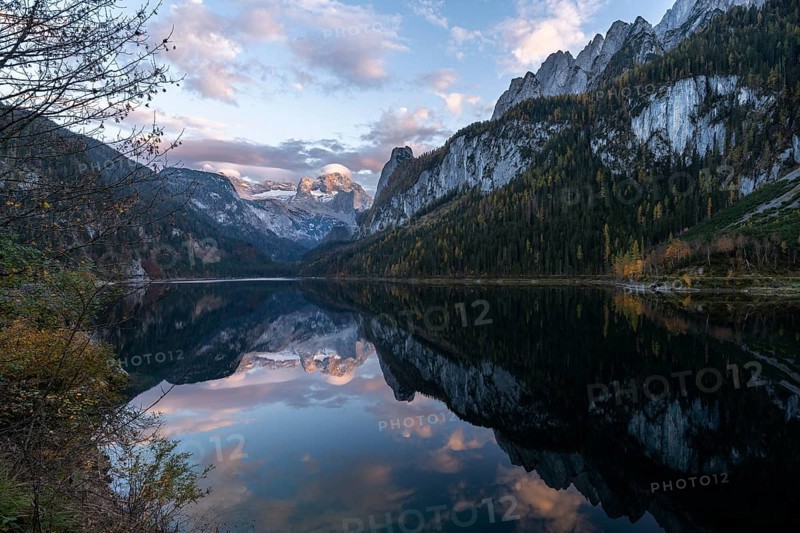 The Vordere Gosausee lake in autumn with a view of the Dachstein mountain range. The Gosaukamm on the right. Good weather, blue sky, a few clouds. In the evening, at sunset. Reflection. Vorderer Gosausee, Gosau, Gosau valley, Salzkammergut, Upper Austria, Austria, Europe