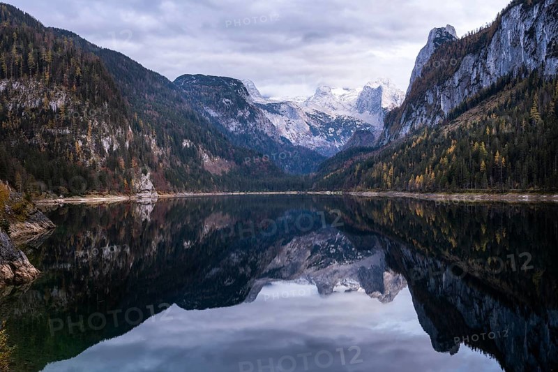 The Vordere Gosausee lake in autumn with a view of the Dachstein mountain range. The Gosaukamm on the right. Clouds in the sky. Vorderer Gosausee, Gosau, Gosau valley, Salzkammergut, Upper Austria, Austria, Europe