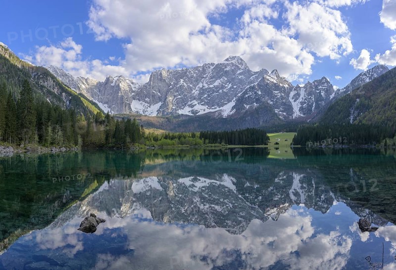 The Mangart mountain range reflected in Lake Fusine, Tarvisio, province of Udine, Italy, Europe