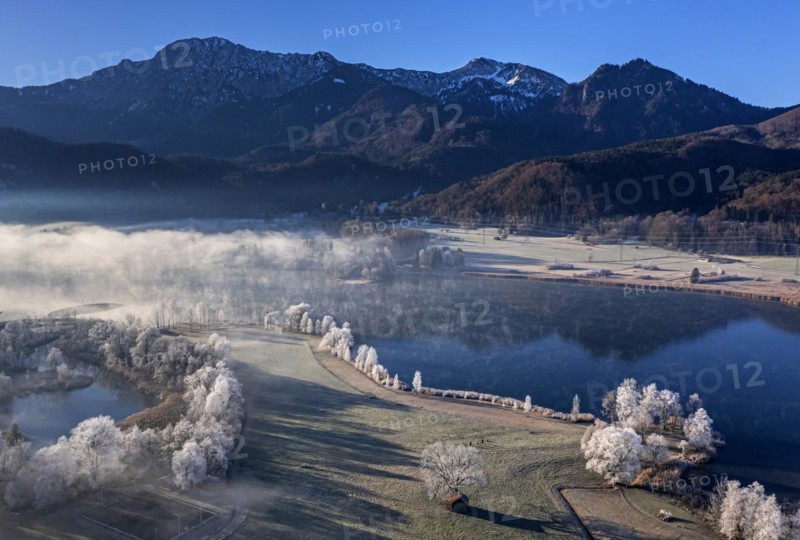 Aerial view of a lake in front of mountains in winter, hoarfrost, morning light, view of Herzogstand and Heimgarten, Lake Kochel, foothills of the Alps, Bavaria, Germany, Europe