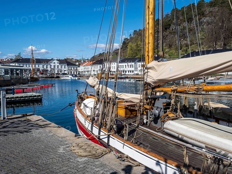At the seaside in Risor, a traditional village with wooden white houses at the southern norwegian coast, Norway, Europe