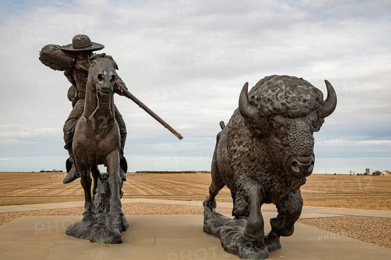 Oakley, Kansas - A sculpture of Buffalo Bill (William Frederick Cody) on horseback shooting a buffalo at the Buffalo Bill Cultural Center. The sculpture is by Charlie Norton.