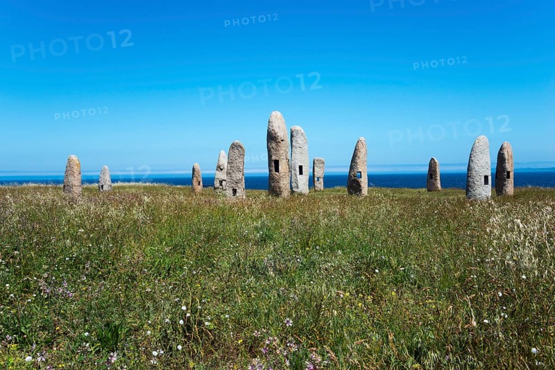 Group of standing stones in a meadow, surrounded by nature and under a blue sky with the sea in the background, Menhires por la Paz, menhirs symbolising peace, Campo de la Rata, A Coruña, A Coruna, La Coruña, La Coruna, Galicia, Spain, Europe