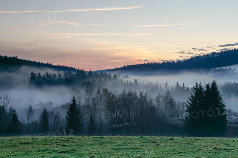 Autumnal evening mood with fog in the valley and in the forests of the Bavarian Forest National Park close to Frauenau