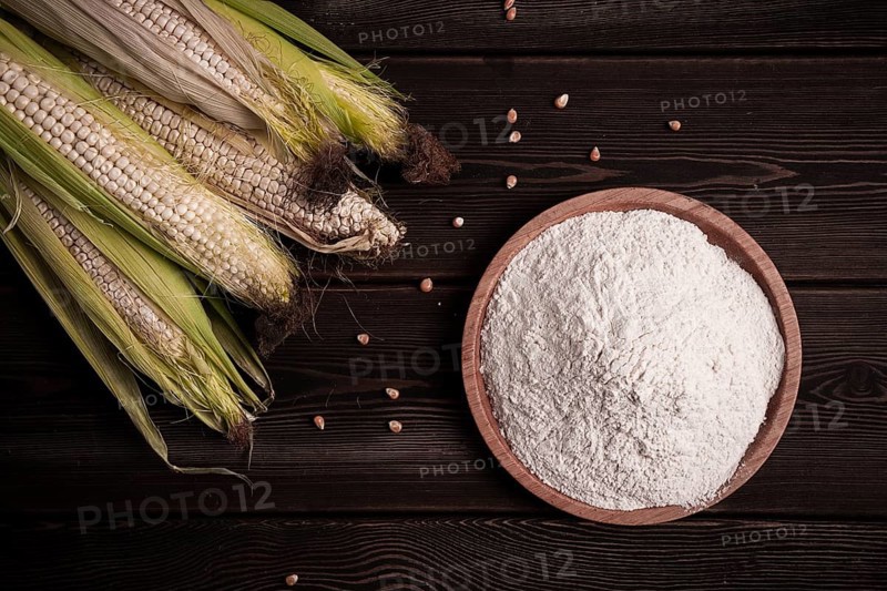 Corn cobs, corn flour, on a wooden table, top view, close-up, rustic, selective focus, dairy corn