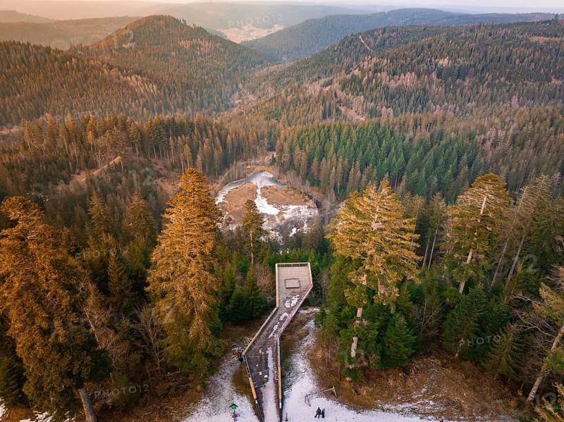 Panoramic view from the wooden walkway over snow-covered hills and forests, Ellbachseeblick viewing platform, Baiersbronn, Black Forest, Germany, Europe