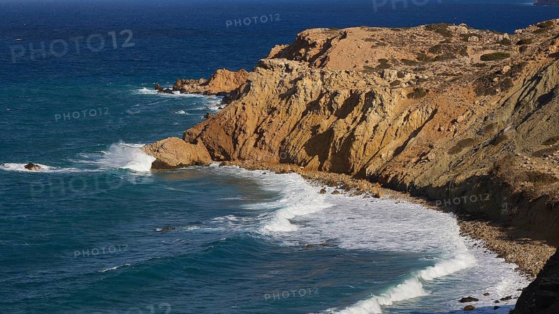 Steep cliffs with rolling waves under a clear sky, west coast, Karpathos, Dodecanese, Greek Islands, Greece, Europe