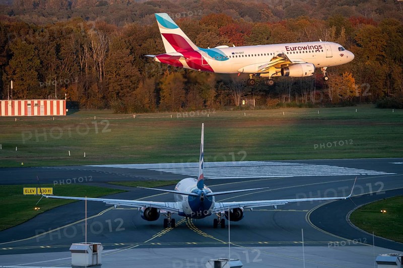Eurowings Airbus A319-132, landing at Cologne-Bonn Airport, Sunexpress Boeing 737 waiting for take-off, CGN, North Rhine-Westphalia, Germany, Europe